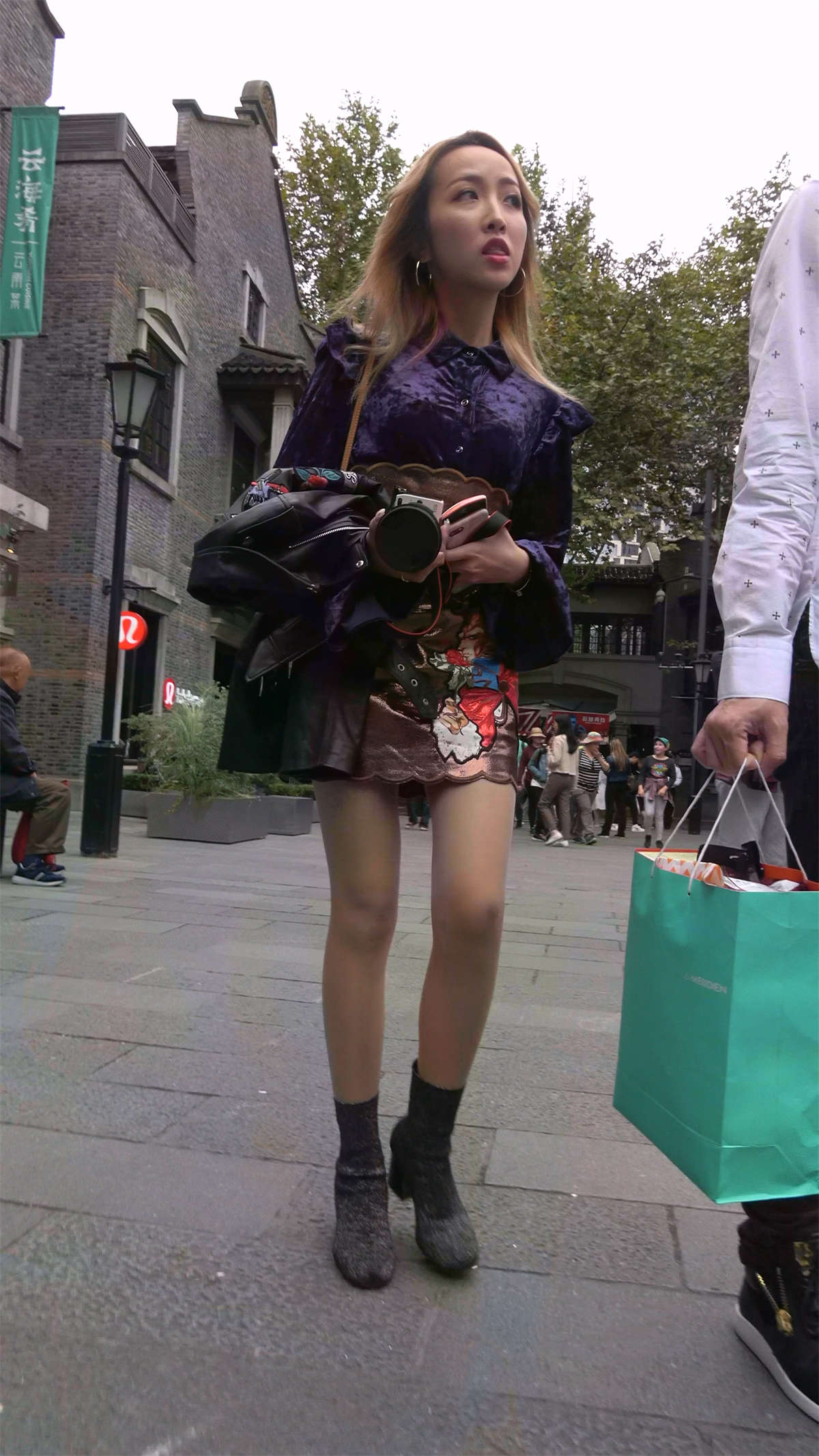 手持单反的时尚美裙美腿姑娘-日更街拍
